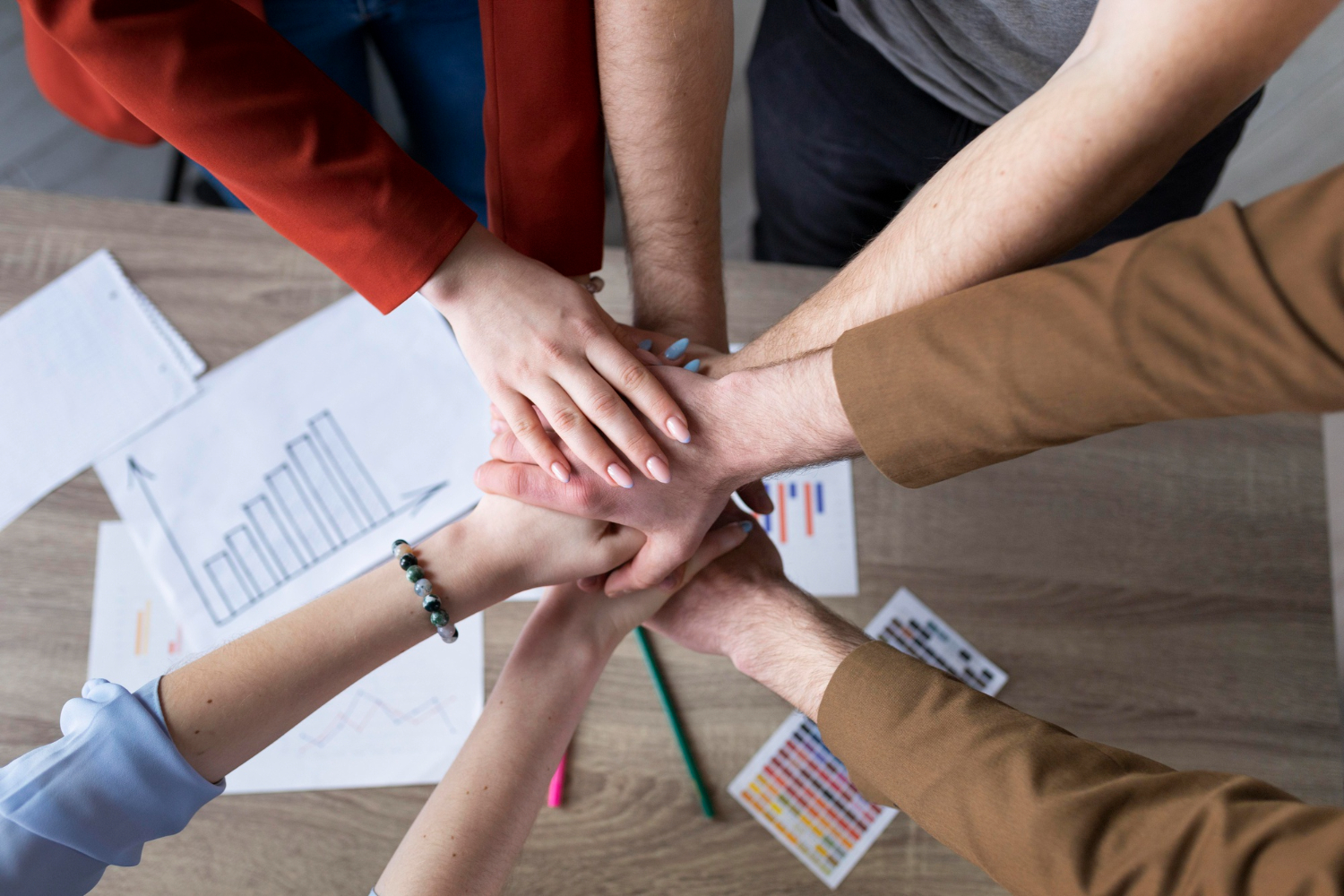 group-coworkers-putting-their-hands-together